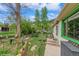 View of a private and well-maintained backyard with beautiful landscaping and a small playhouse at 3384 Avenue F, Kittredge, CO 80457