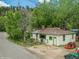 Charming exterior view of home with trees and well-maintained yard at 3384 Avenue F, Kittredge, CO 80457