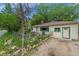 Cozy home exterior with a rock-lined garden and a well-manicured lawn at 3384 Avenue F, Kittredge, CO 80457