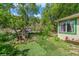 Charming front yard with a small playhouse and lush greenery at 3384 Avenue F, Kittredge, CO 80457