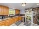 Functional kitchen featuring wood cabinets, tile countertops, and modern appliances at 3384 Avenue F, Kittredge, CO 80457