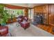 Inviting living room with a stone fireplace, wood walls, and cozy seating at 3384 Avenue F, Kittredge, CO 80457