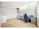 Well-lit bedroom showcasing built-in shelves, desk, and neutral carpet, creating a cozy and functional space at 15974 E Loyola Dr, Aurora, CO 80013