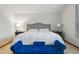 Bright bedroom showcasing a king-sized bed, upholstered headboard, side tables and stylish blue bench at 15974 E Loyola Dr, Aurora, CO 80013