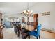 Elegant dining room with a vaulted ceiling, a chandelier, a wooden table with seating for ten, and view to the living room at 15974 E Loyola Dr, Aurora, CO 80013