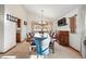 Elegant dining room with a vaulted ceiling, a chandelier, a wooden table with seating for ten, and a large window at 15974 E Loyola Dr, Aurora, CO 80013