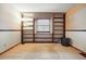 Cozy living room features built-in shelving and a window with decorative fabric valance and plush carpeting at 15974 E Loyola Dr, Aurora, CO 80013