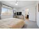 Bright primary bedroom featuring a TV, large window, and easy access to an ensuite bathroom at 9400 E Iliff Ave # 145, Denver, CO 80231