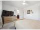 Bright primary bedroom featuring a TV, large window, and easy access to an ensuite bathroom at 9400 E Iliff Ave # 145, Denver, CO 80231