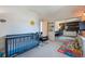 Cozy bedroom with a crib, rocking chair, carpet and sliding mirror doors at 9400 E Iliff Ave # 145, Denver, CO 80231