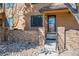 Exterior view of the townhome featuring the front entrance and walkway at 9400 E Iliff Ave # 145, Denver, CO 80231