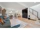 Bright living room features a fireplace, television, and an open floor plan leading to dining area and the kitchen at 9400 E Iliff Ave # 145, Denver, CO 80231