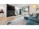 Spacious living room with a fireplace, open staircase, and views to the entry and front yard at 9400 E Iliff Ave # 145, Denver, CO 80231