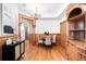 Formal dining room showcases wood paneling and trim, chandelier, and hardwood floors at 1022 N Pearl St # 202, Denver, CO 80203