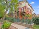 Charming exterior featuring brick accents, a balcony with flags, and a wrought iron fence at 1022 N Pearl St # 202, Denver, CO 80203