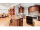 Gourmet kitchen with custom wood cabinetry, granite countertops, and stainless steel appliances at 1022 N Pearl St # 202, Denver, CO 80203