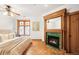 Comfortable main bedroom with a fireplace, warm wooden accents, and a window view at 1022 N Pearl St # 202, Denver, CO 80203