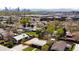 Overhead shot shows a residential area with views of the city skyline and various houses in the neighborhood at 3984 N Cook St, Denver, CO 80205