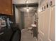 Bathroom featuring white tiles and a shower-tub combination, vanity with sink, and a toilet at 3984 N Cook St, Denver, CO 80205