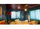 Bedroom with dark blue walls, unmade bed, and ceiling fan at 3984 N Cook St, Denver, CO 80205