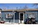 Cozy single-story home with blue siding, front door, security bars, and well-kept yard at 3984 N Cook St, Denver, CO 80205