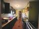 Galley kitchen featuring dark cabinets, linoleum floors, and an adjacent pantry at 3984 N Cook St, Denver, CO 80205