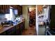 Galley kitchen featuring dark cabinets, linoleum floors, and view into an adjacent pantry at 3984 N Cook St, Denver, CO 80205