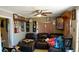 Comfortable living room with dark leather sectional couch, ceiling fan, and eclectic decor at 3984 N Cook St, Denver, CO 80205