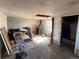 The room shows bare walls, scattered items and personal belongings, and a visible hole in the ceiling at 3984 N Cook St, Denver, CO 80205