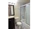 Bathroom featuring modern vanity, toilet, and tiled shower with glass doors at 909 S Dawson Way # 19, Aurora, CO 80012