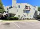 Exterior elevation of building with multiple balconies, stairs and parking in front at 909 S Dawson Way # 19, Aurora, CO 80012