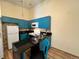 Bright kitchen featuring modern blue cabinets, tiled backsplash, and sleek countertops at 909 S Dawson Way # 19, Aurora, CO 80012