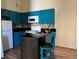 Bright kitchen featuring modern blue cabinets, tiled backsplash, and sleek countertops at 909 S Dawson Way # 19, Aurora, CO 80012