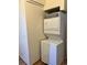 A white stacked washer and dryer set in the laundry area for in-home convenience at 909 S Dawson Way # 19, Aurora, CO 80012