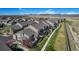 Aerial view of the townhome community showcasing the layout, landscaping, surrounding green spaces, and mountain views at 4739 Raven Run, Broomfield, CO 80023