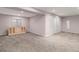 Spacious finished basement featuring neutral carpet, a storage cabinet and closet at 4739 Raven Run, Broomfield, CO 80023