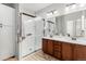 Modern bathroom with dual sinks, a walk-in shower with glass enclosure, and stylish fixtures at 4739 Raven Run, Broomfield, CO 80023
