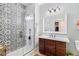 Modern bathroom features a walk-in shower with decorative tile and a vanity with granite countertop at 4739 Raven Run, Broomfield, CO 80023