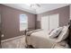 Comfortable bedroom with an arched window, soft carpet and a double door closet at 4739 Raven Run, Broomfield, CO 80023
