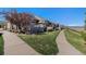 Well-maintained townhome exteriors featuring stone accents, landscaping, and pathway access to the open space and mountain views at 4739 Raven Run, Broomfield, CO 80023