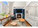 Stylish living room with built-in shelving, a modern fireplace, hardwood floors, and large windows at 4739 Raven Run, Broomfield, CO 80023