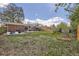 Spacious backyard with patio, seating, grass, and garden beds, perfect for outdoor enjoyment at 2201 S Lowell Blvd, Denver, CO 80219