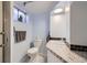 Cozy basement bathroom with marble floors, vanity with granite countertops, and light blue walls at 2201 S Lowell Blvd, Denver, CO 80219