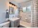 Elegant bathroom with marble tile, modern vanity, and updated fixtures at 2201 S Lowell Blvd, Denver, CO 80219