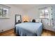 Cozy bedroom with natural light, hardwood floors and comfortable furnishings at 2201 S Lowell Blvd, Denver, CO 80219