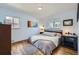 Bright bedroom with hardwood floors, large windows, and neutral decor at 2201 S Lowell Blvd, Denver, CO 80219