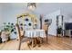 Inviting dining area with a charming table, display cabinet, and hardwood floors at 2201 S Lowell Blvd, Denver, CO 80219
