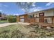 Charming single-story home with brick accents, a red door, an attached garage, and a cozy front porch at 2201 S Lowell Blvd, Denver, CO 80219