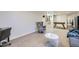 Spacious basement living area with stylish chair and a large grey couch with an area for games at 2201 S Lowell Blvd, Denver, CO 80219