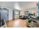 Cozy living room with hardwood floors, a TV, a grey sofa, a large window, and a modern floor lamp at 2201 S Lowell Blvd, Denver, CO 80219